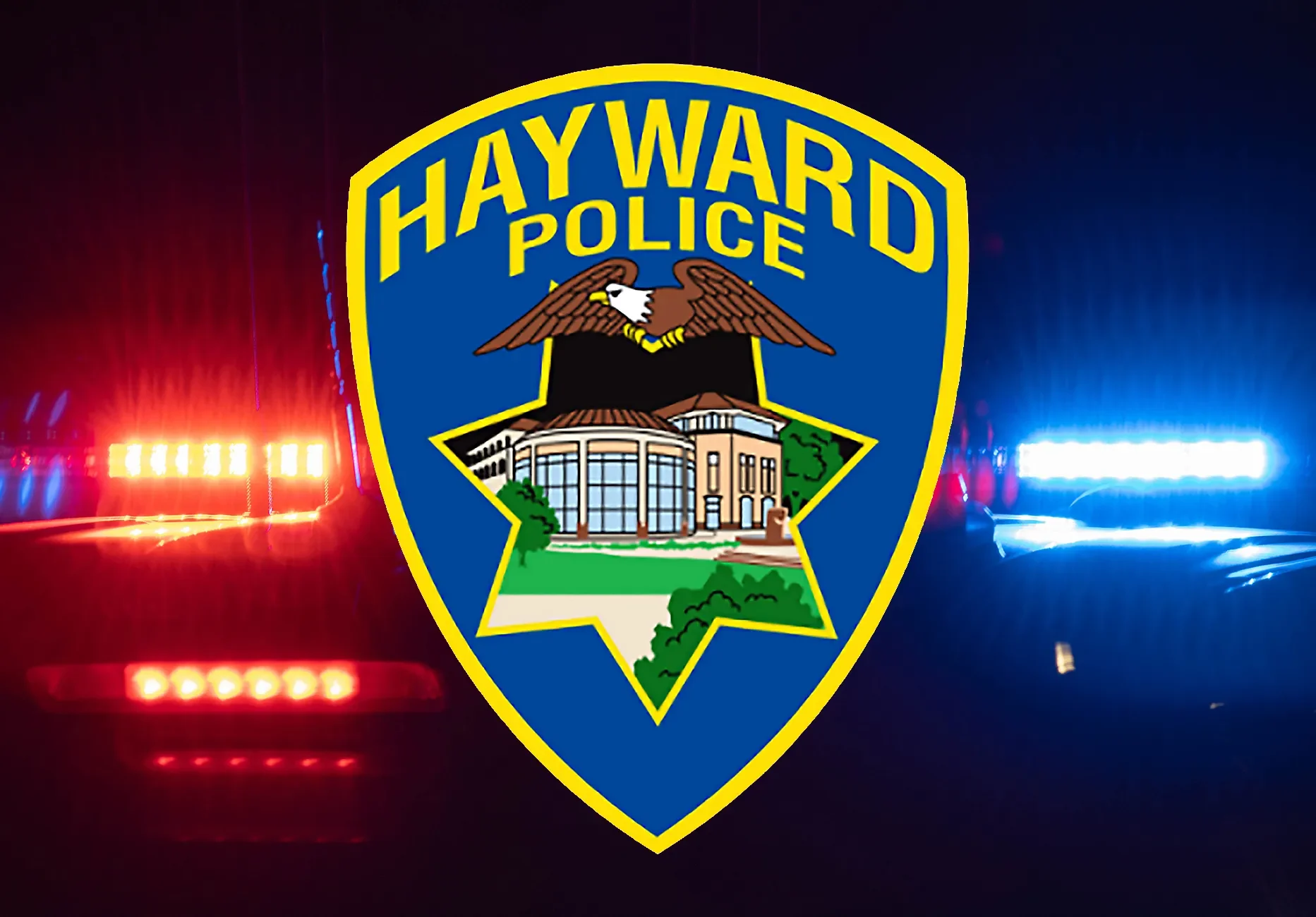 Hayward Police badge in front of police car with flashing red and blue lights