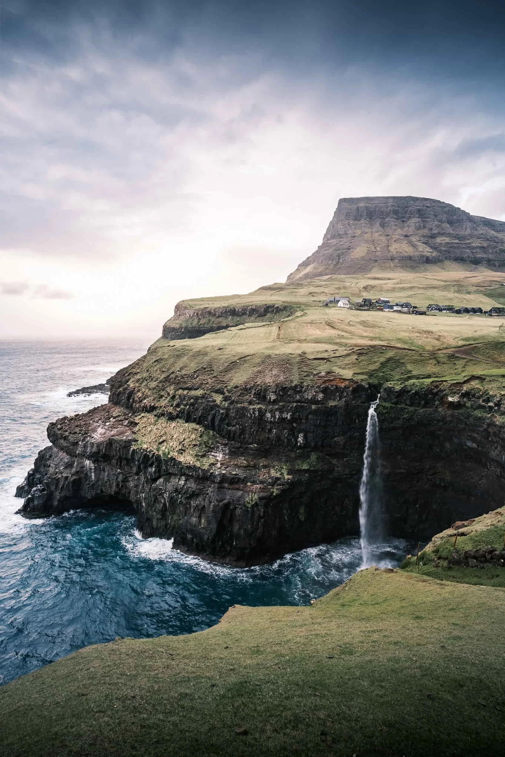 Destination icon: Múlafossur waterfall in Gásadalur, visual asset for regional marketing.