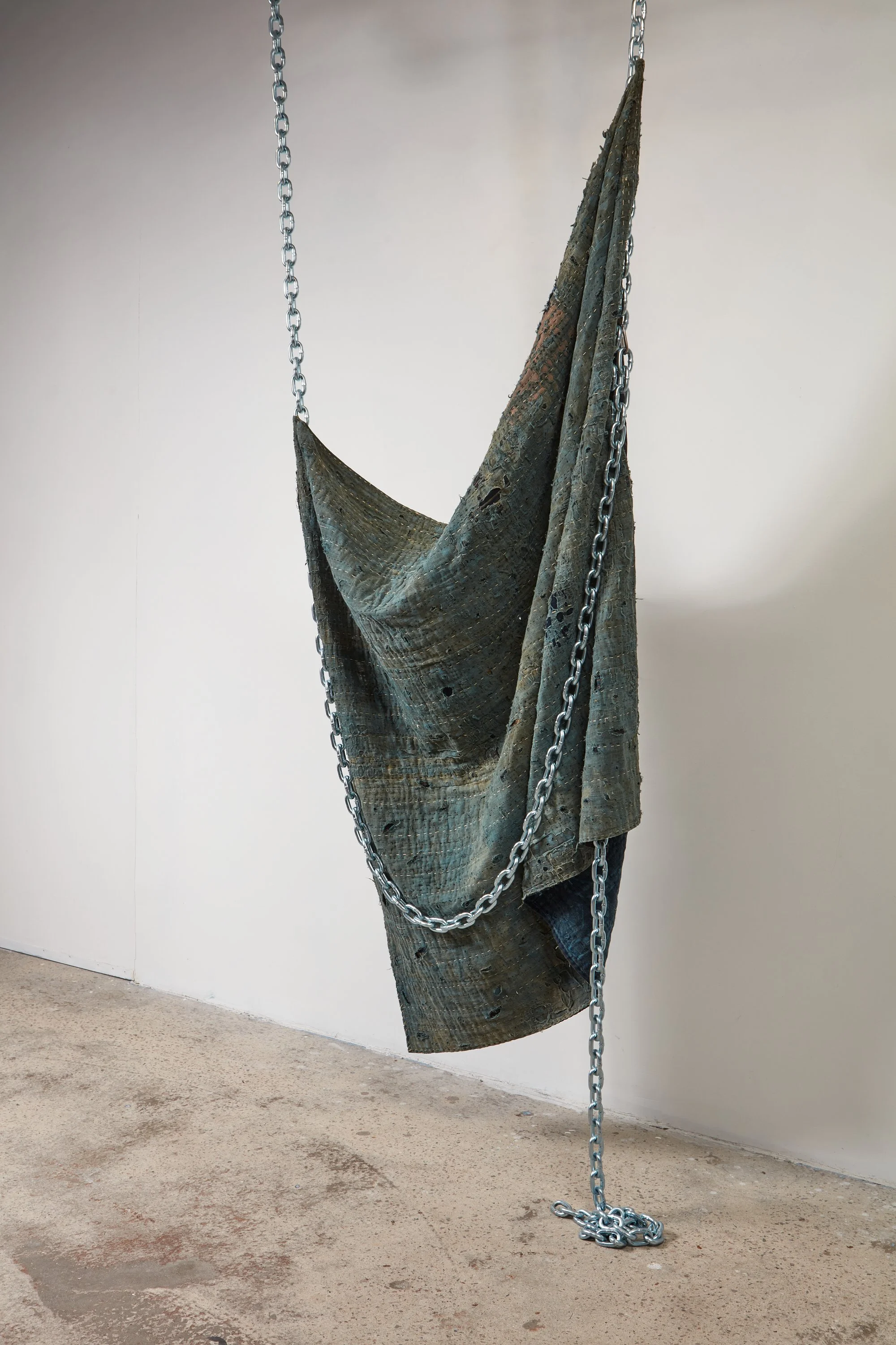  Wells Watson 
 Hungry, Suffocating, 2025 
 Moth-eaten boro, chains 