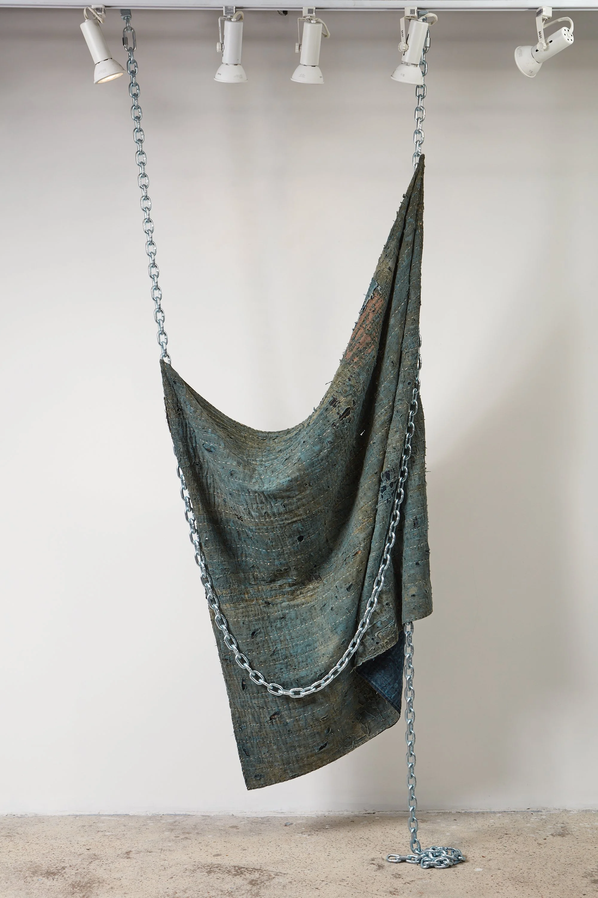  Wells Watson 
 Hungry, Suffocating, 2025 
 Moth-eaten boro, chains 