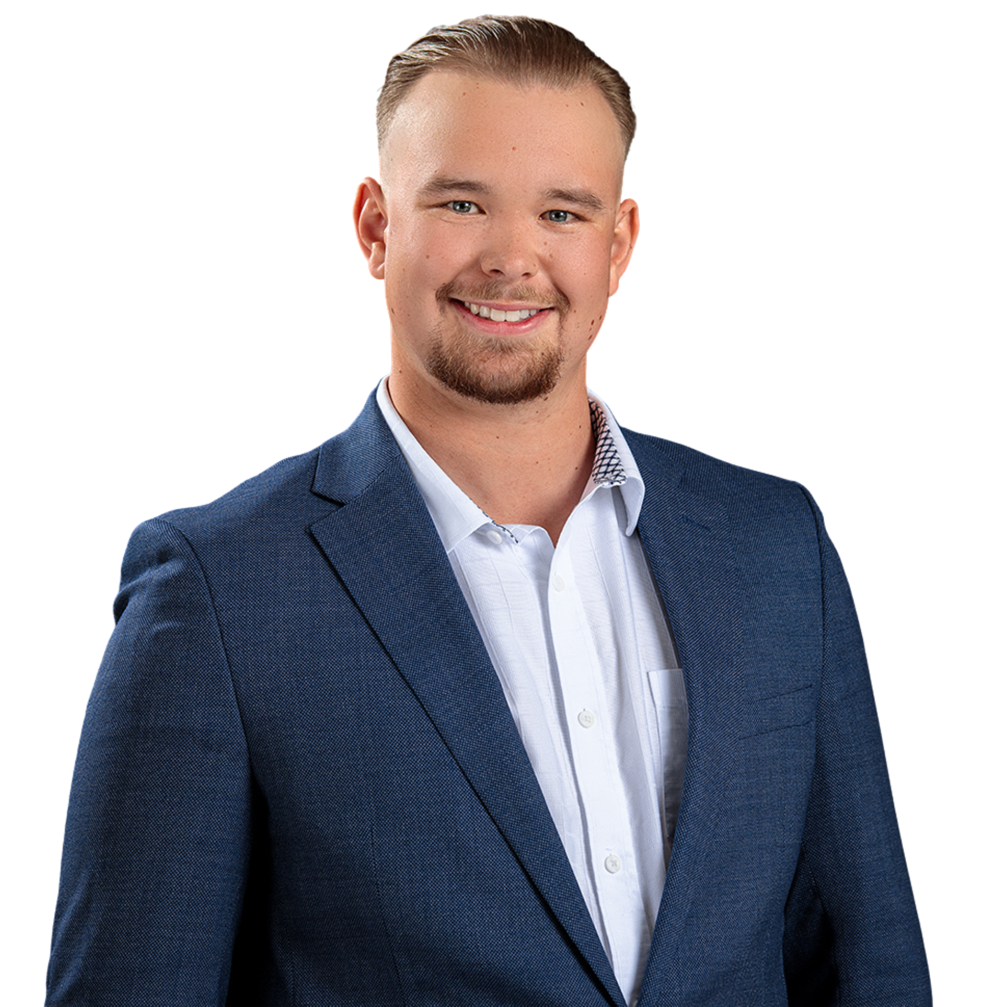 A young man with short blond hair, a beard, dressed in a blue blazer and white button-up shirt, smiling with a white background.