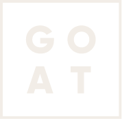 White background with the word 'GOAT' in cream, vertically stacked.