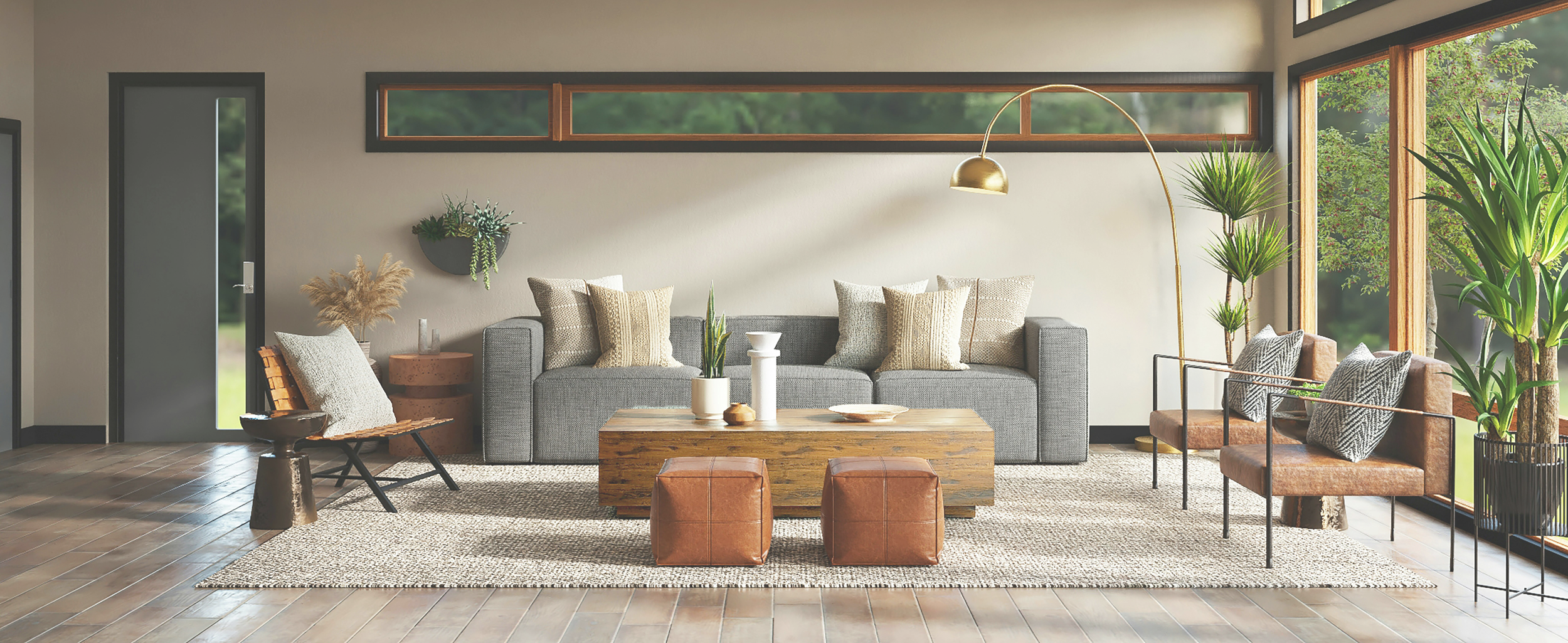 Modern living room with gray sofa, brown leather chairs, wooden coffee table, large windows with greenery outside, and various plants inside.