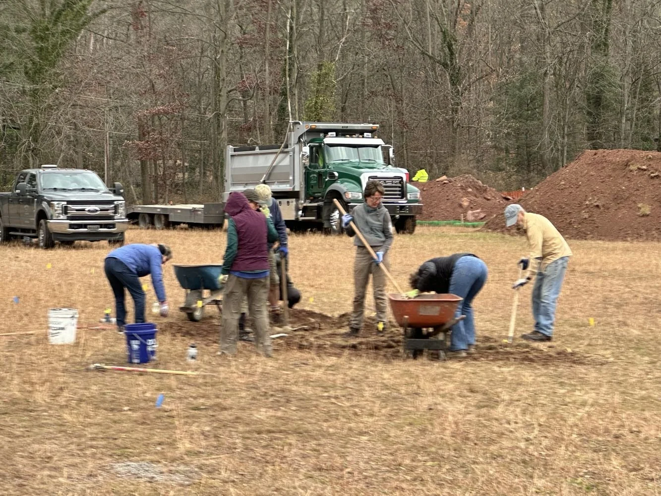 Group of people planting or gardening outdoors in a Soldiers Field