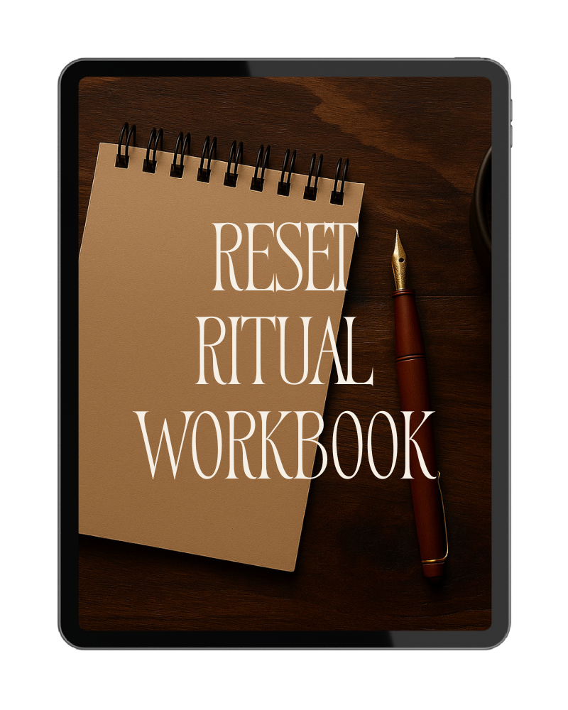 A tablet displaying a notebook labeled "Reset Ritual Workbook" and a pen on a wooden surface.
