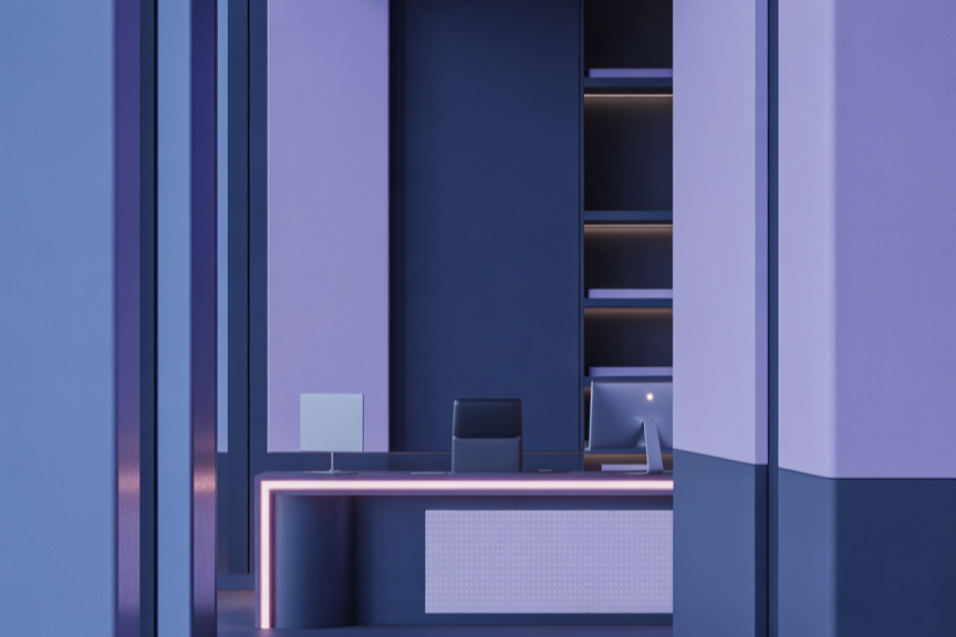 Modern office reception desk with computer, monitor, and chair in a sleek, minimalist space with purple and black tones.