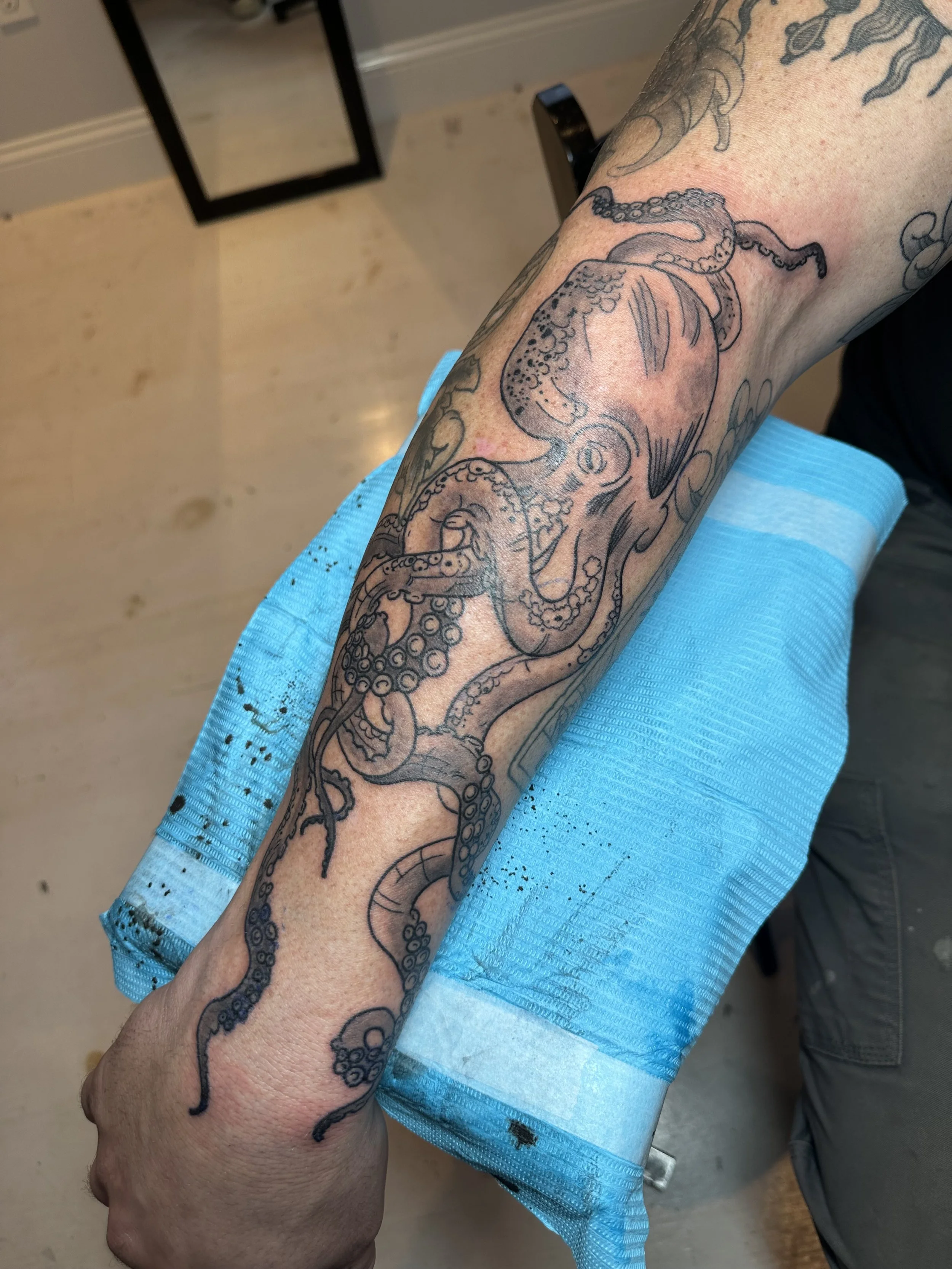 Tattoo of an octopus on a person's arm.