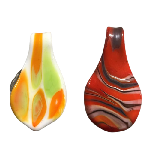 Two decorative glass pendants with colorful swirl patterns, one with orange, green, and white, and the other with red, black, and orange.