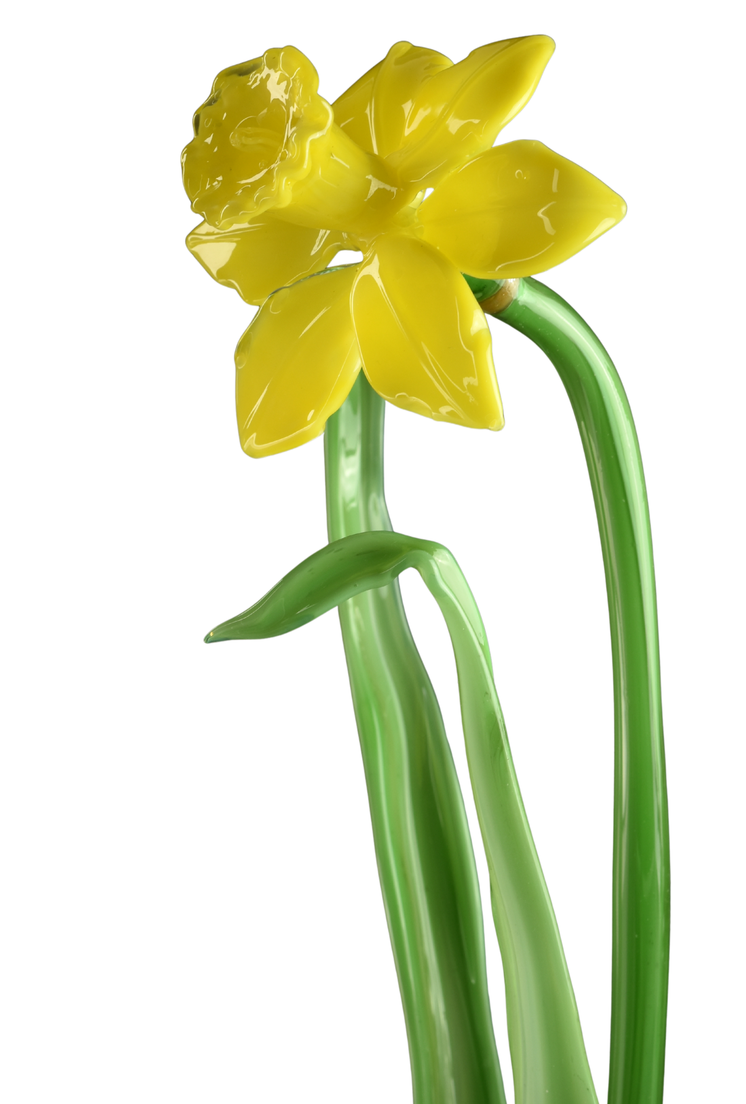 Close-up of a yellow plastic flower with green stems against a black background.
