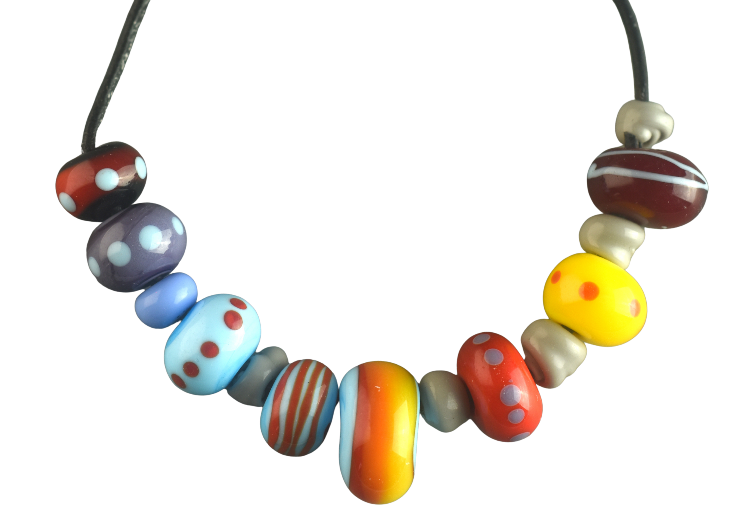Colorful glass beads with various patterns, arranged in a circle on a black background.