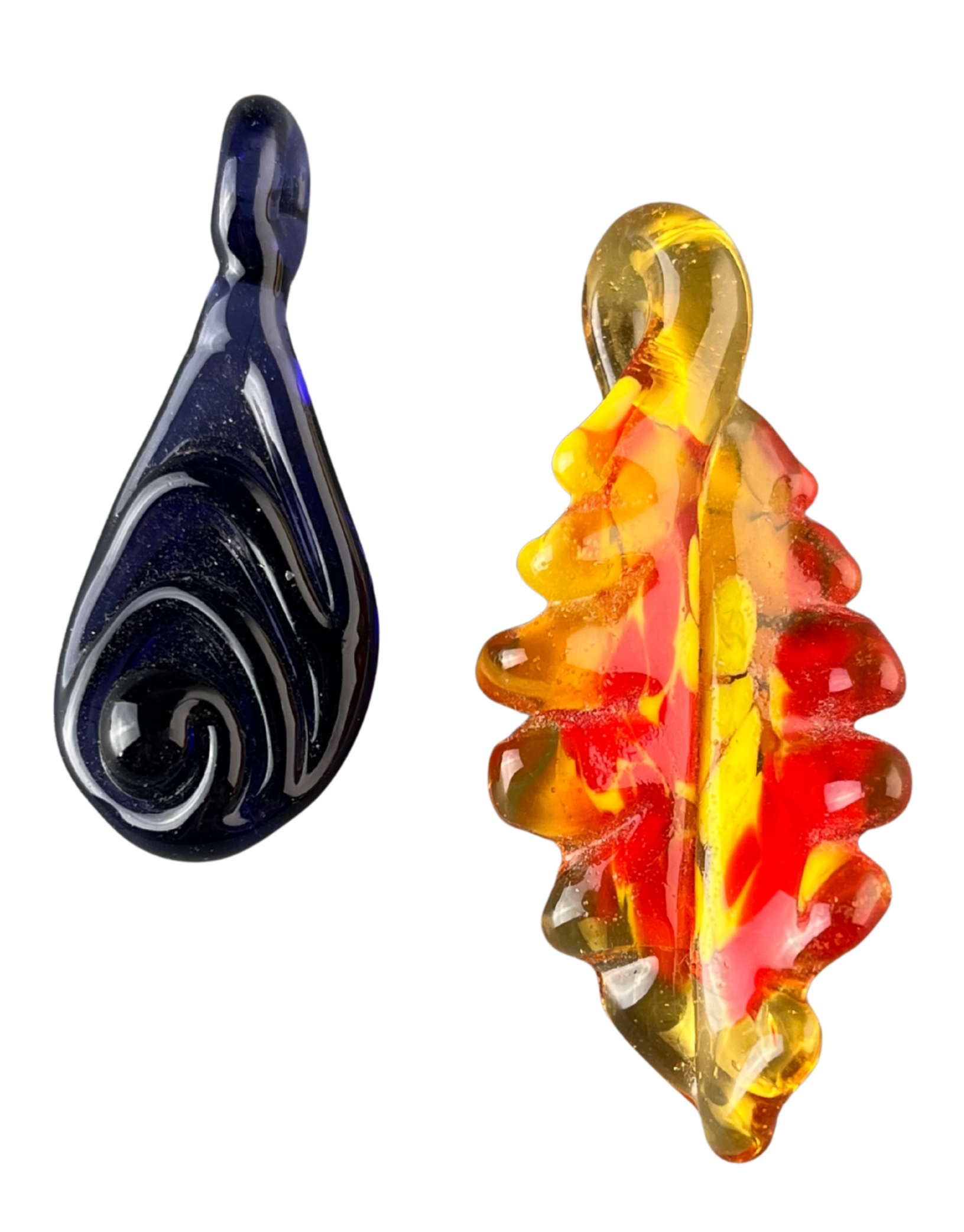 Close-up of two glass pendants, one dark blue and the other multi-colored with red, yellow, and orange hues