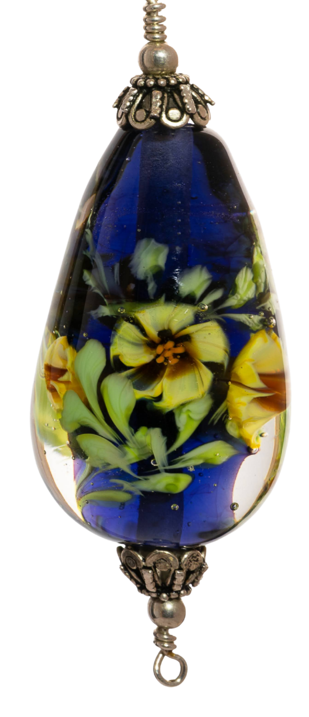 A glass bead with a floral design inside, featuring yellow, green, and black colors, connected to metallic decorative caps and a clasp.