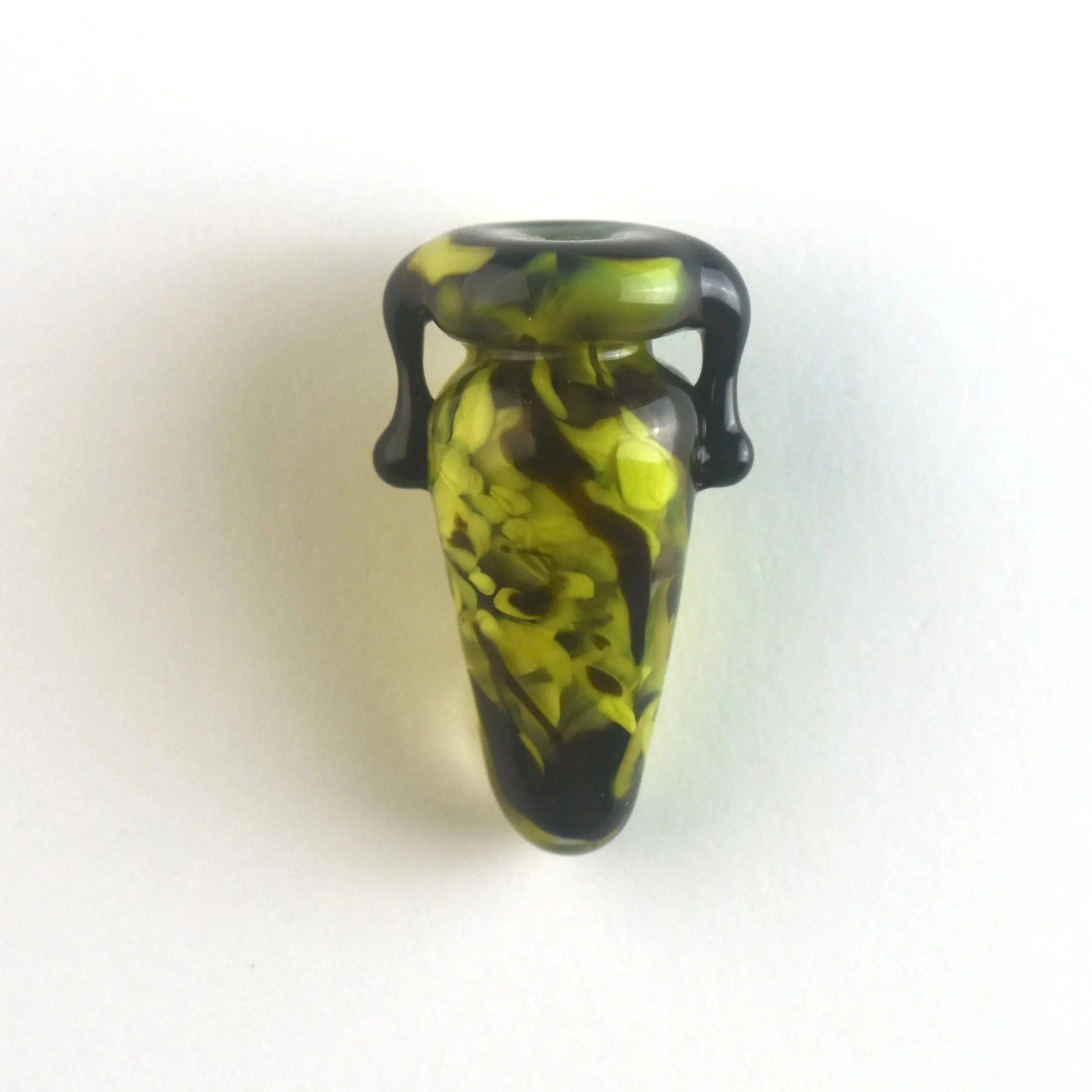 Colorful marbled glass vase with black handles, set against a white background.