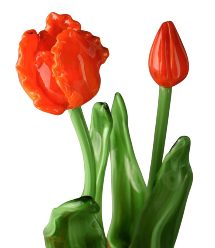 A glass sculpture of two red tulips with green stems and leaves.
