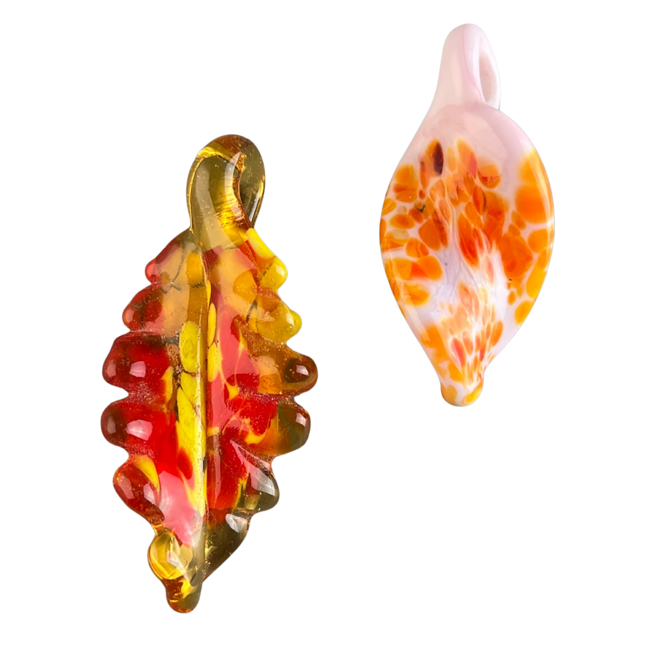 Colorful glass pendants, sculptures with abstract shapes and swirls, featuring orange, yellow, red, and pink hues, reflective surface, set against a white background.