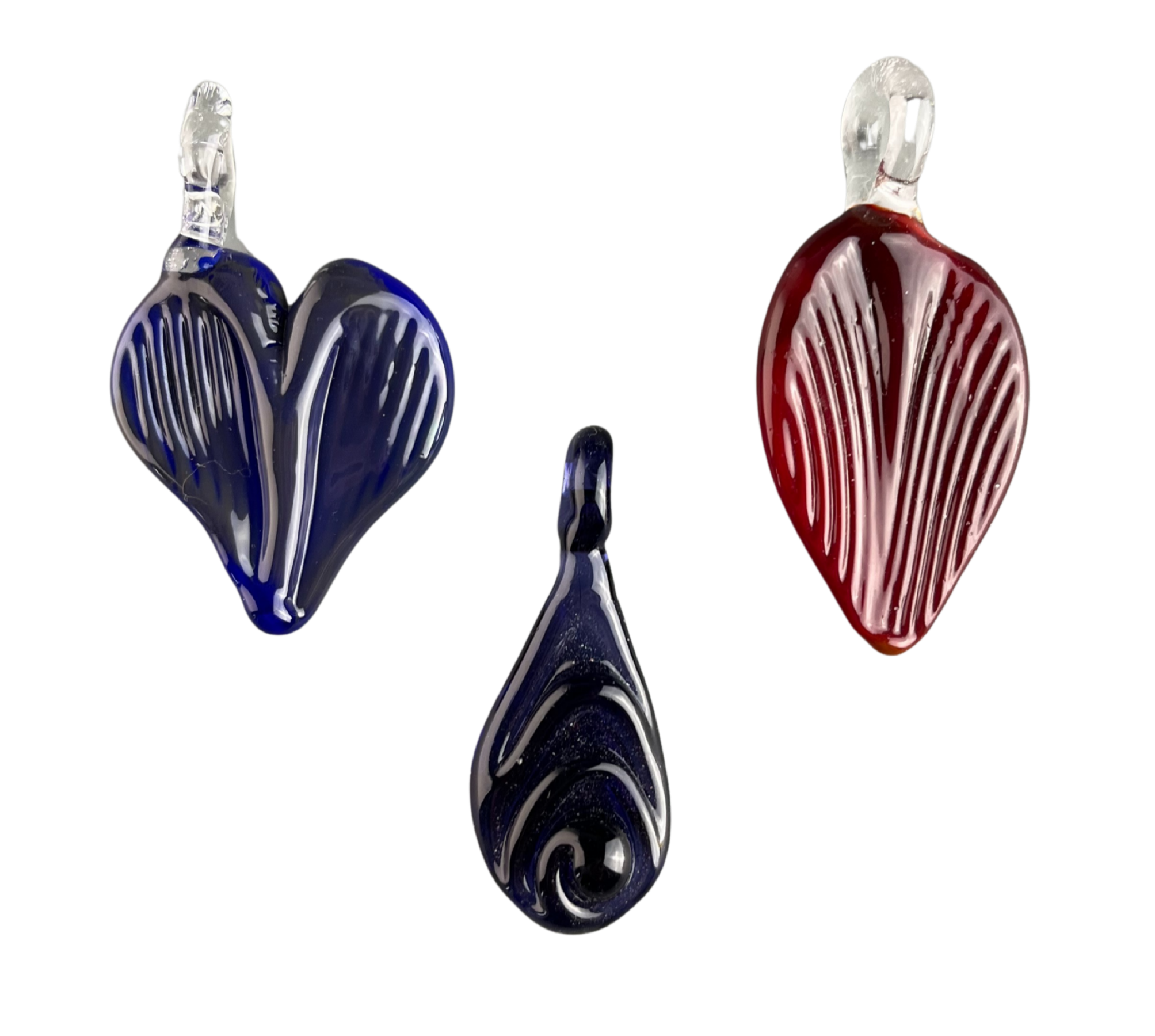 Colorful glass pendants shaped like hearts with vertical striped patterns and swirling designs.
