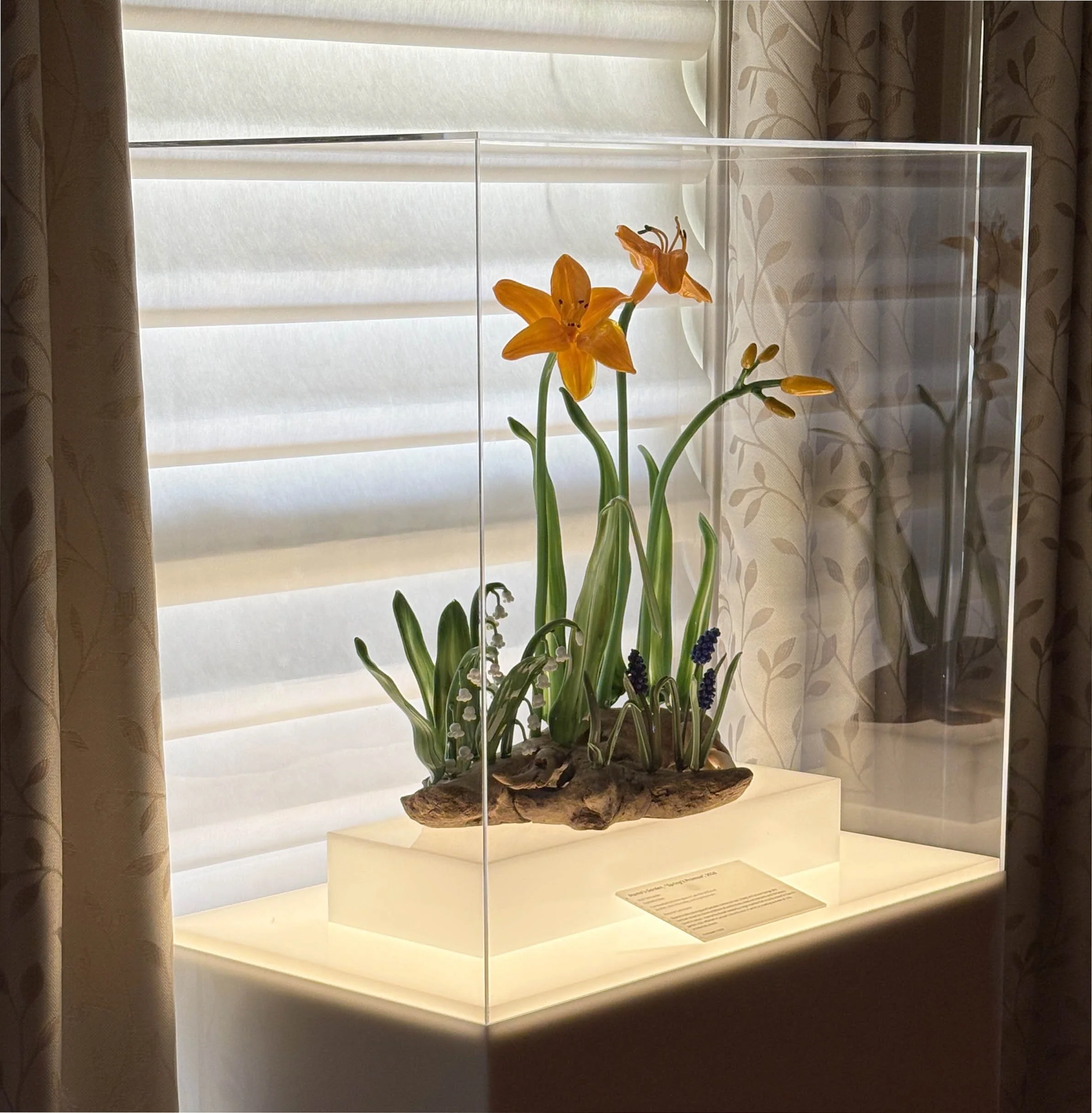 Glass sculpture by Vicki Schneider, featuring 2 large day lilies and other spring flowers