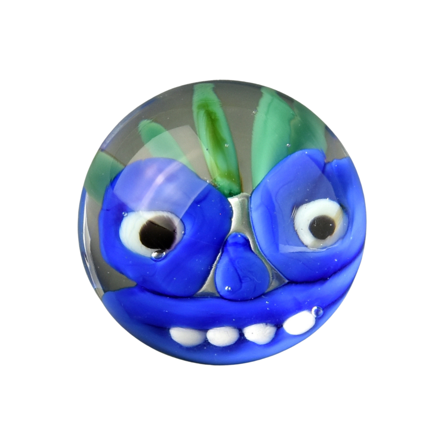 Colorful glass marble with a blue face, white teeth, large black eyes, green and blue wings, and a green antenna on top, set against a black background.