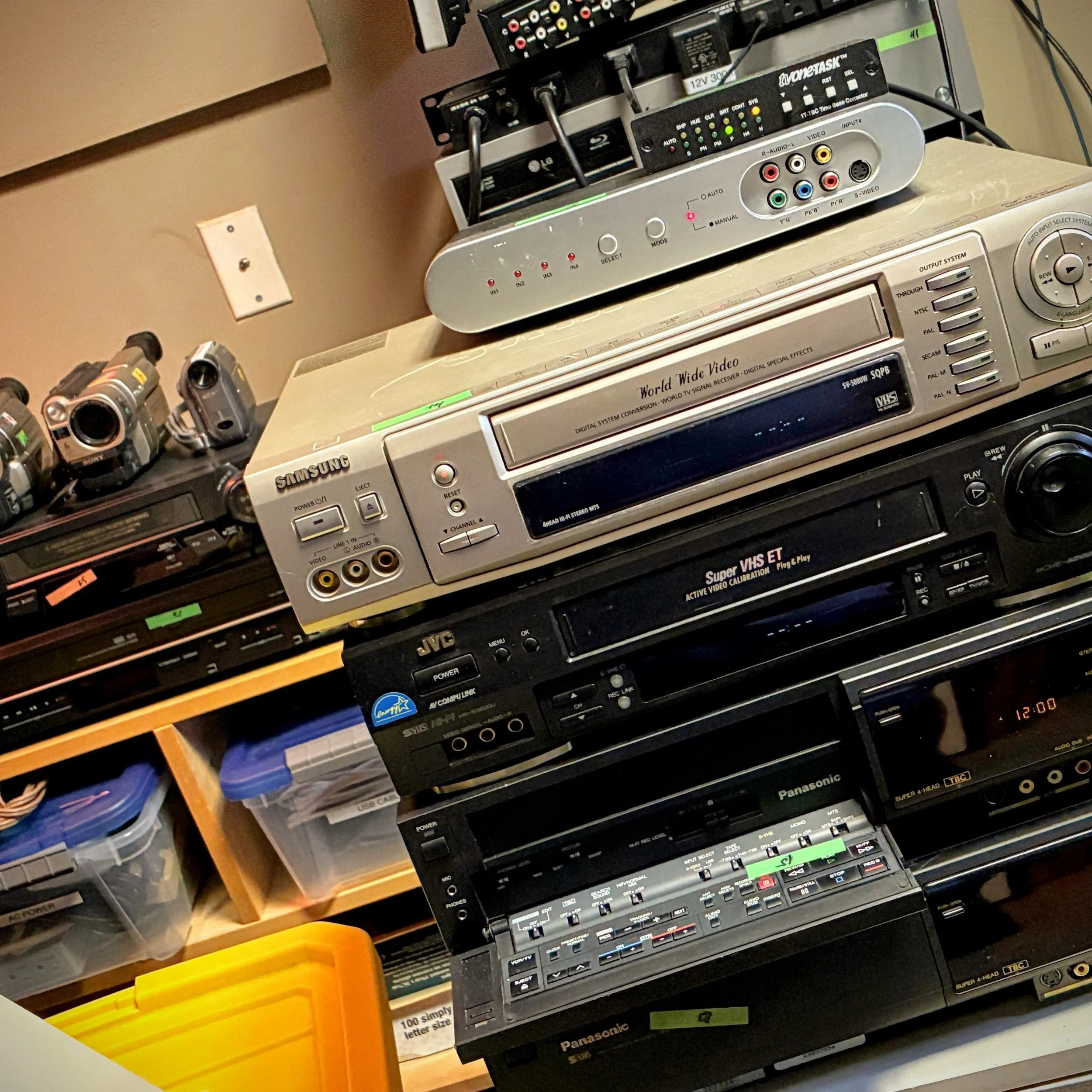 A stack of VHS VCRs in the London video capture studio at Cygnals Multimedia.