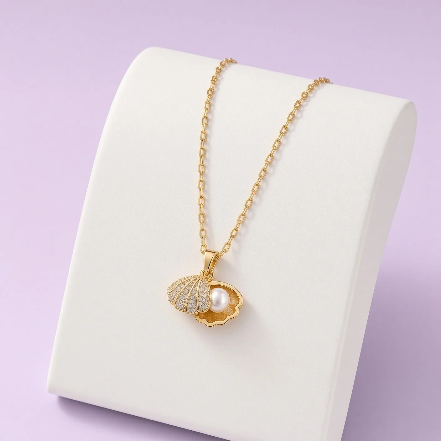 Christmas Box Eleven necklace detail: gold-plated open-shell pendant with pavé lid and white pearl