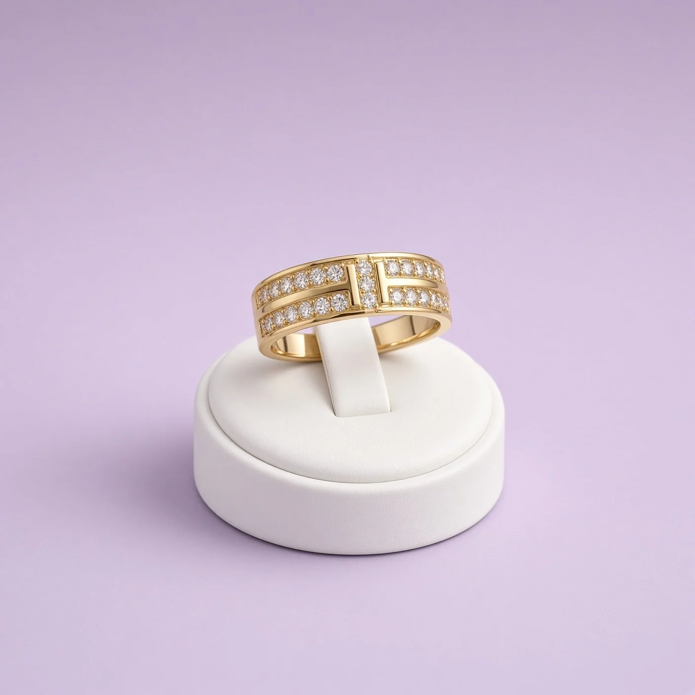 Gold two-row ring with H-shaped stone pattern from Laroc Jewel on white stand, lilac background