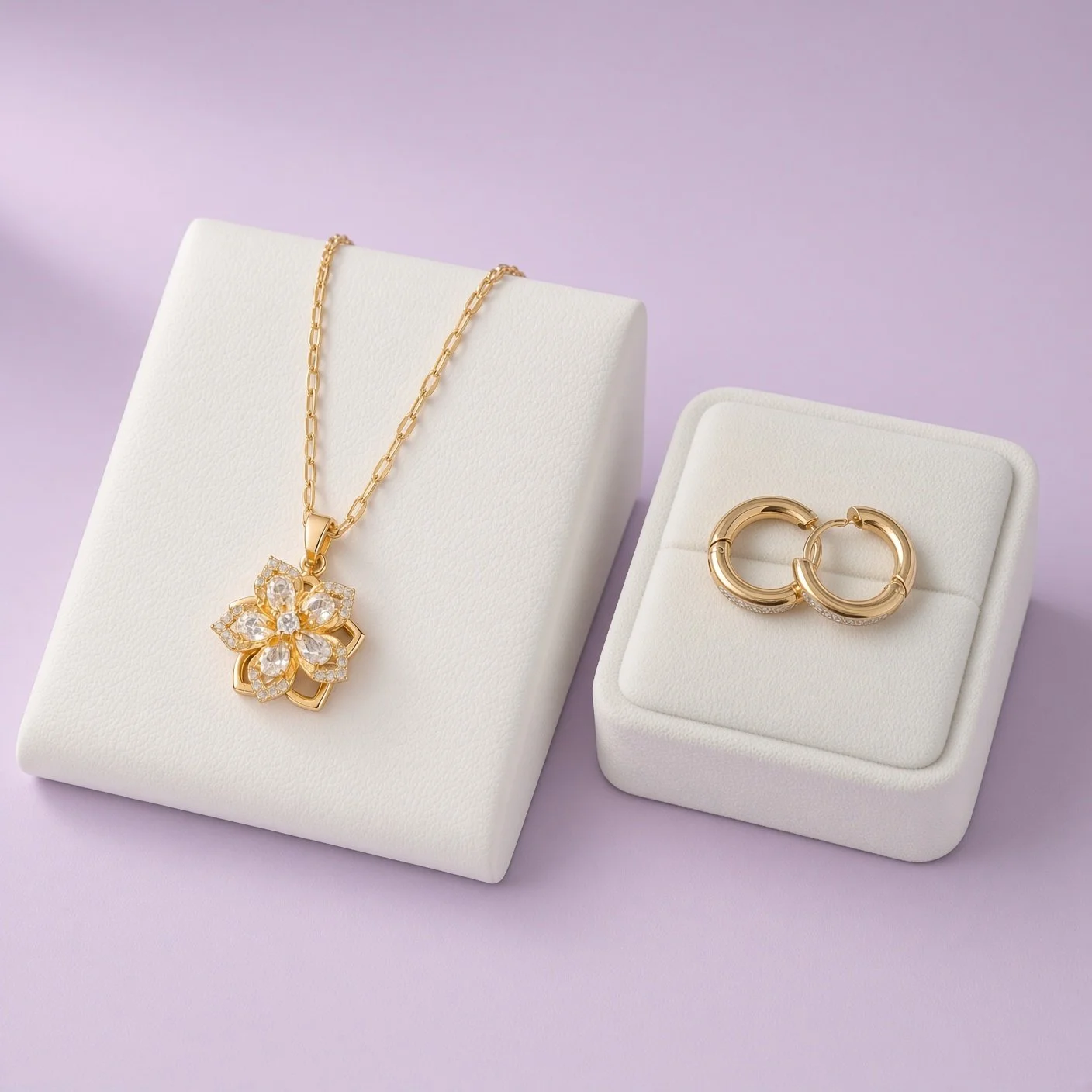 Gold-plated flower pendant necklace and small hoop earrings with tiny stones