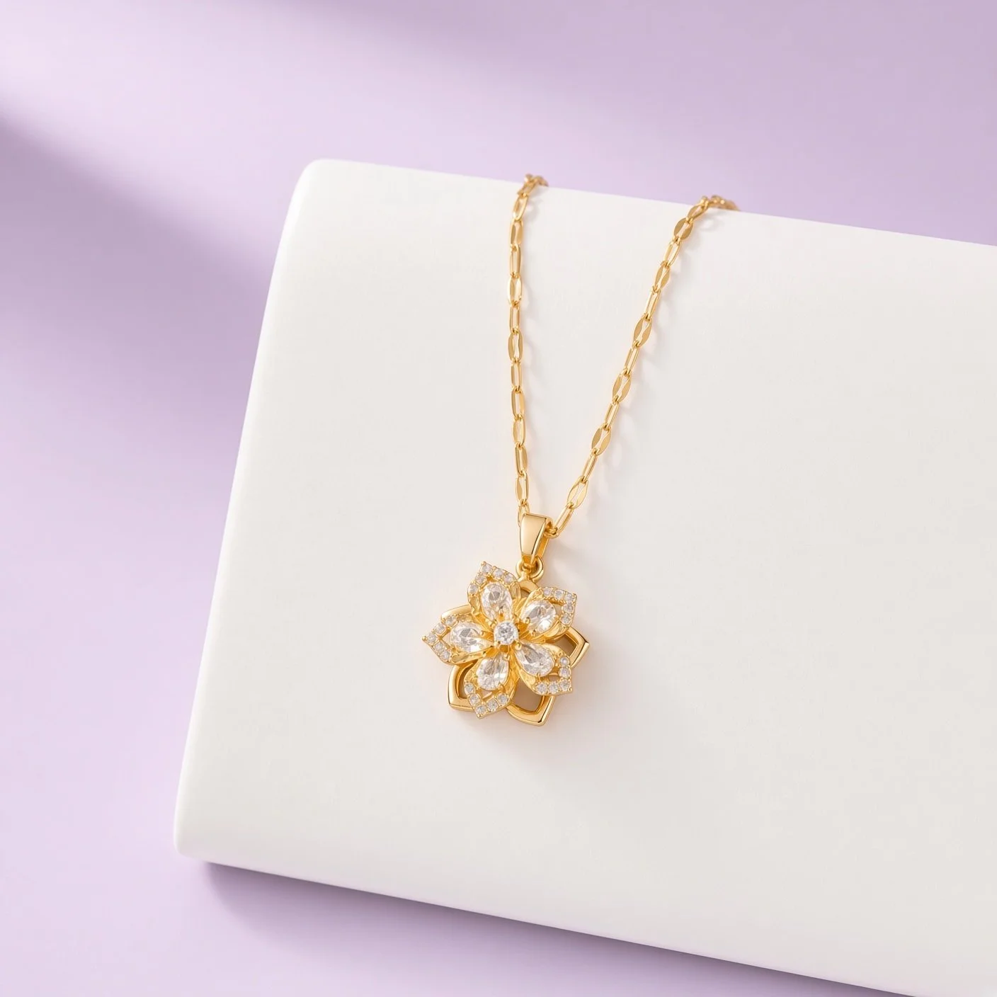 Gold-plated flower pendant necklace set with clear stones