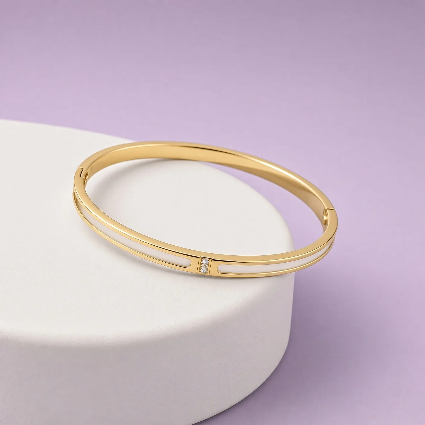 Gold enamel bangle with white stripes and small stones from Christmas Box Four on white stand