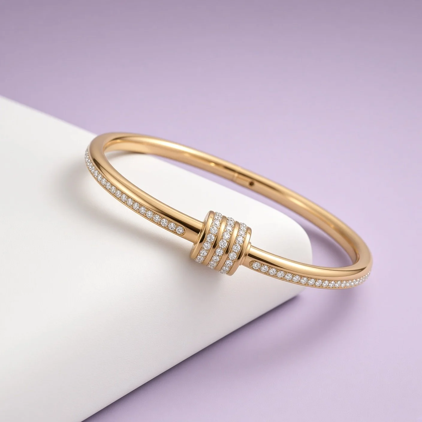 Gold stone-set bangle with center bands and side stones from Christmas Box One on white surface