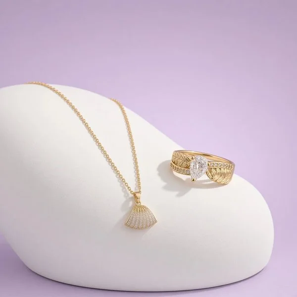 18-karat gold-plated fan pendant necklace and pear-shaped stone ring on a lavender display, a Laroc Jewel Christmas gift set for her, gift-wrapped.
