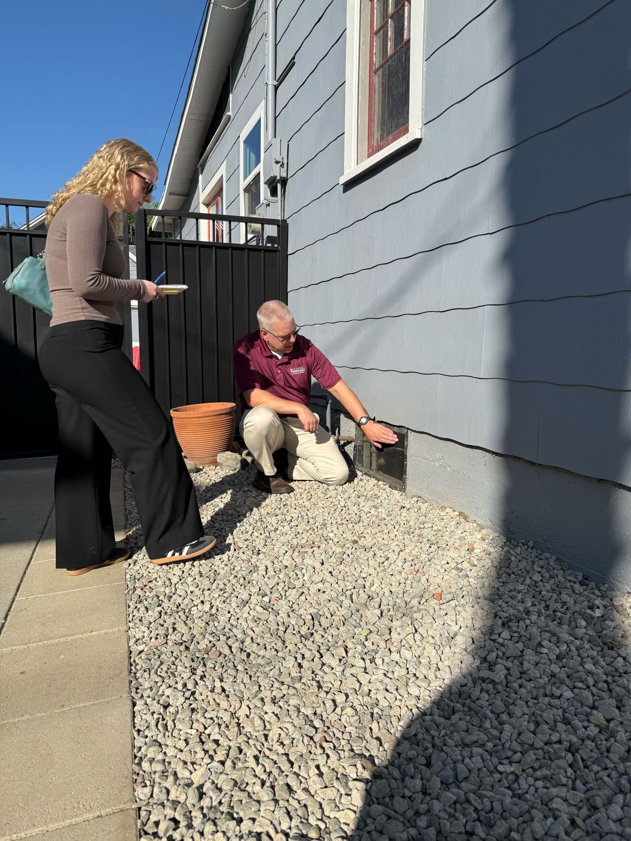 Neighbors examining is house vent is fire rated