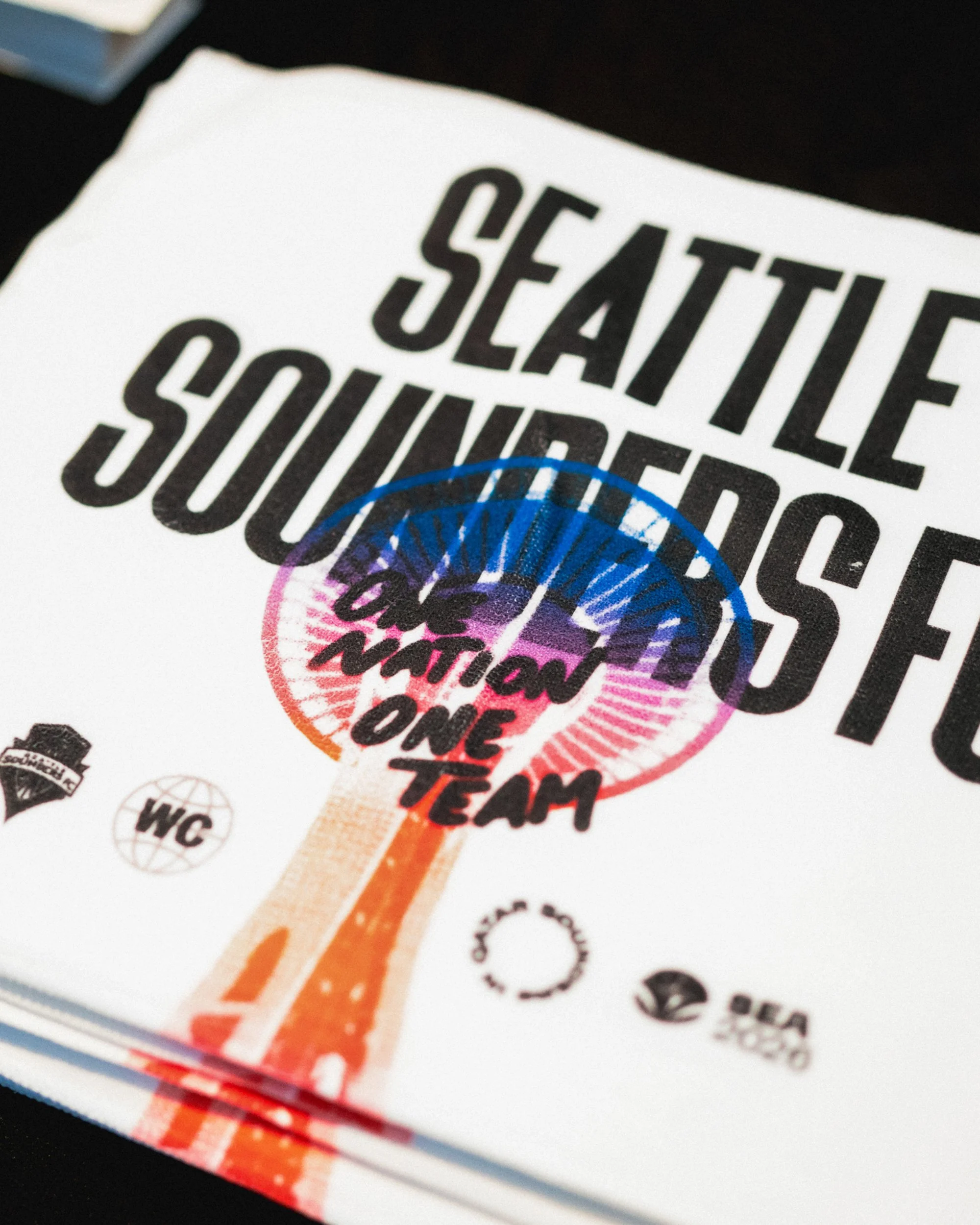 Seattle Sounders FC promotional flyer or magazine cover with the Seattle Space Needle and team logo, celebrating one team.