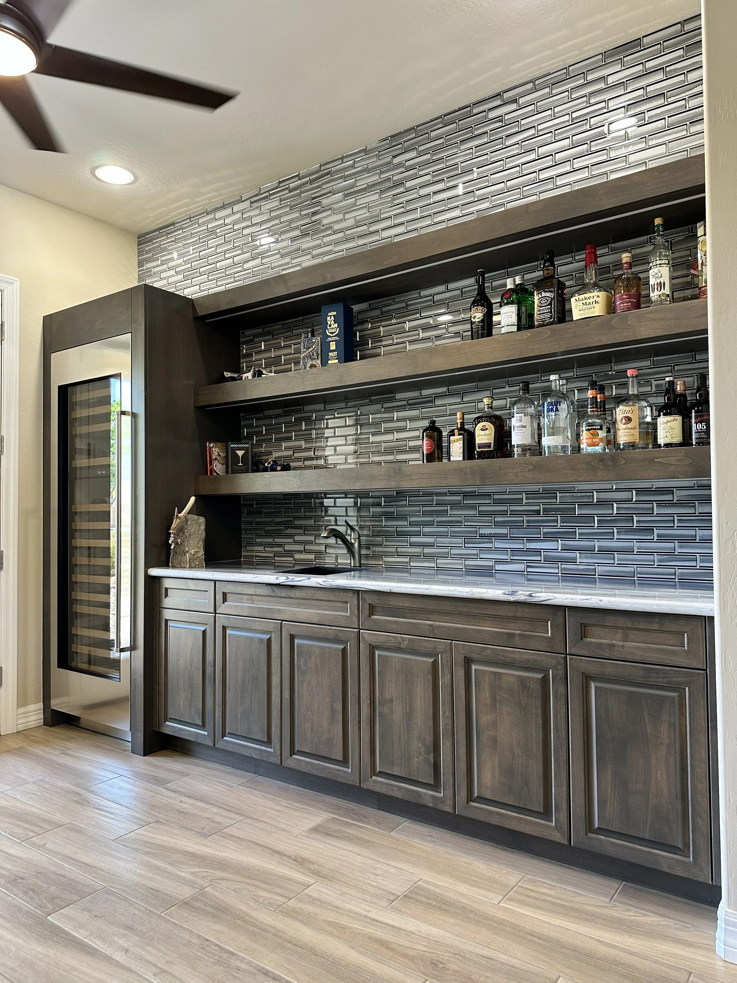 Custom cabinets wetbar floating shelves liquor display mancave