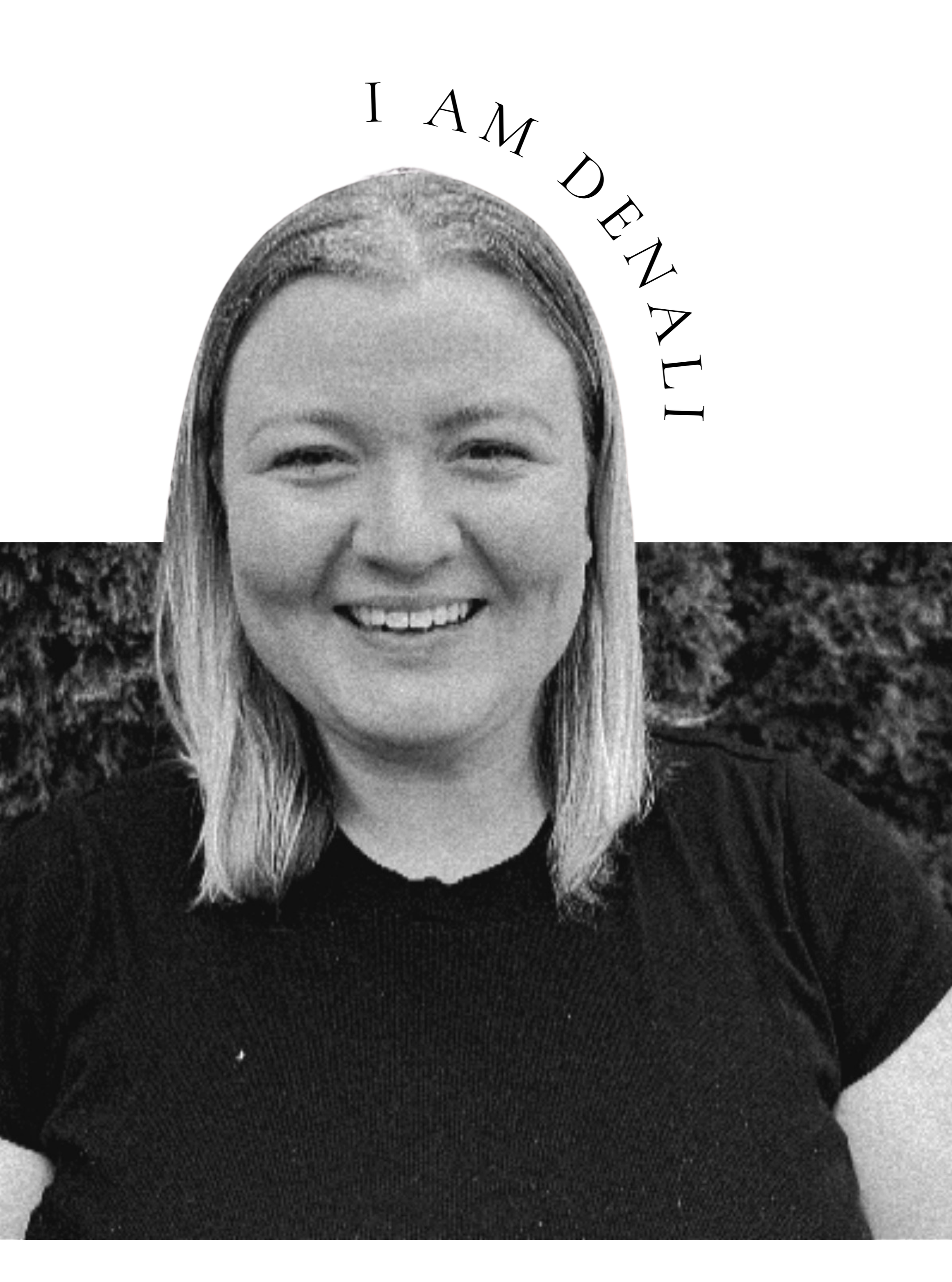 Black and white photo of a smiling woman with shoulder-length hair, wearing a dark shirt, outdoors with bushes in the background.