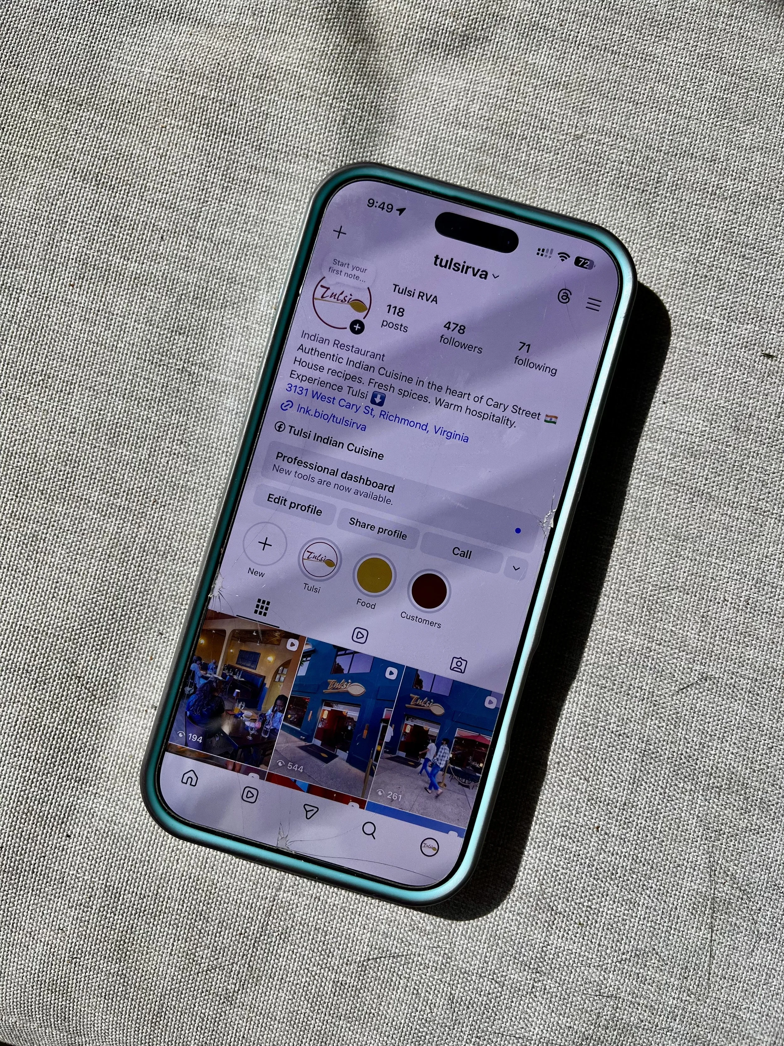 A smartphone displaying the Instagram profile of Tulsi, an Indian restaurant in Richmond, Virginia, resting on a light-colored fabric surface.