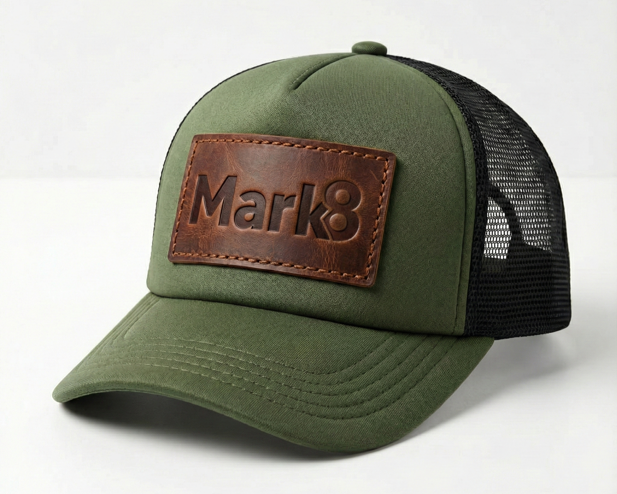 Structured green trucker hat with mesh back and premium leather front patch. A strong choice for brands looking to add texture, warmth, and character to their everyday headwear.