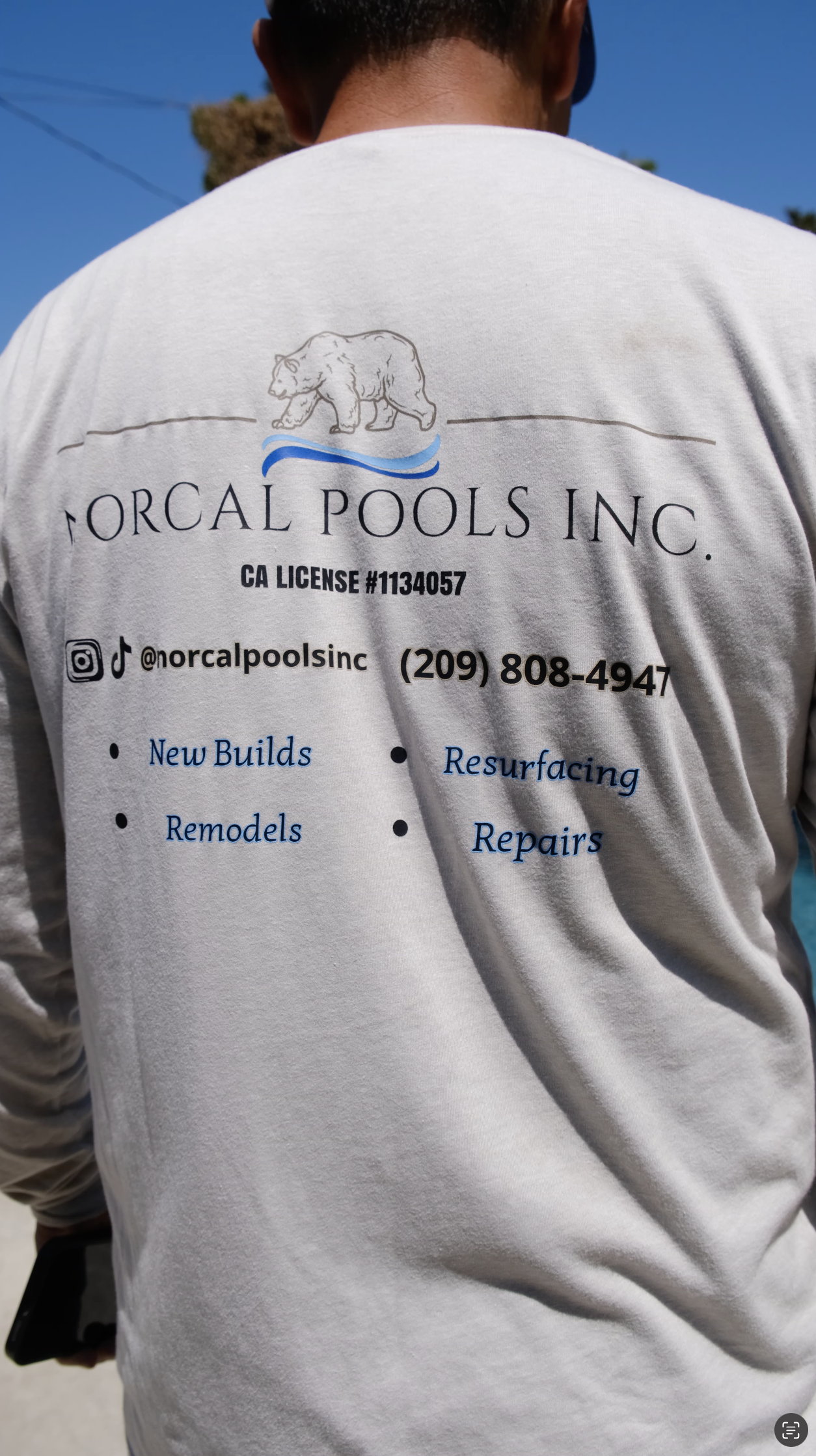 NorCal Pools Inc licensed contractor shirt displaying services including new builds, remodels, resurfacing, and repairs in Northern California