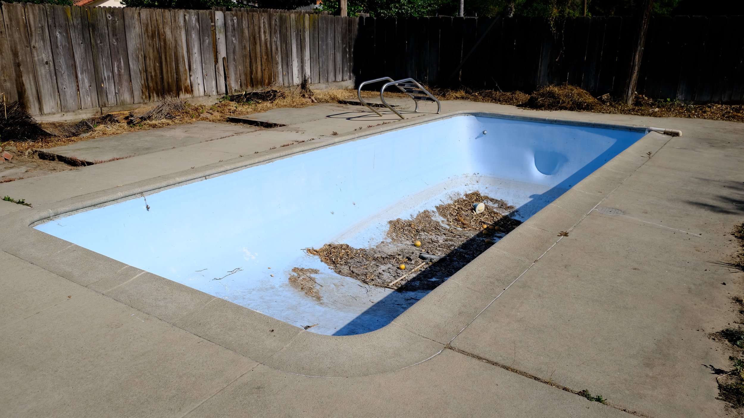 Old damaged pool with deteriorated surface before remodel by NorCal Pools Inc in Northern California