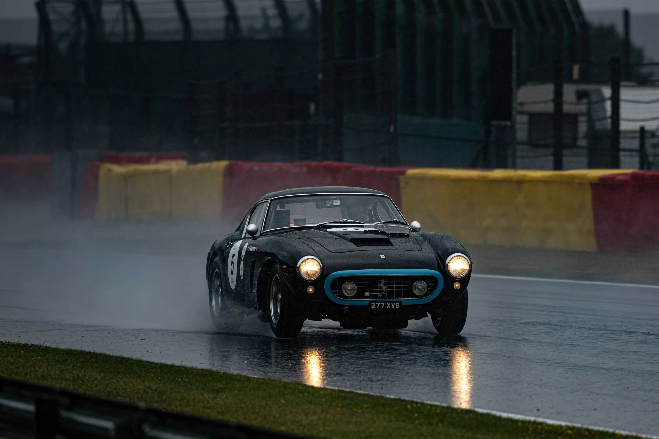 A black Ferrari 250 GT SWB at a rain soaked Spa-Francorchamps during the Spa Classic 2025.