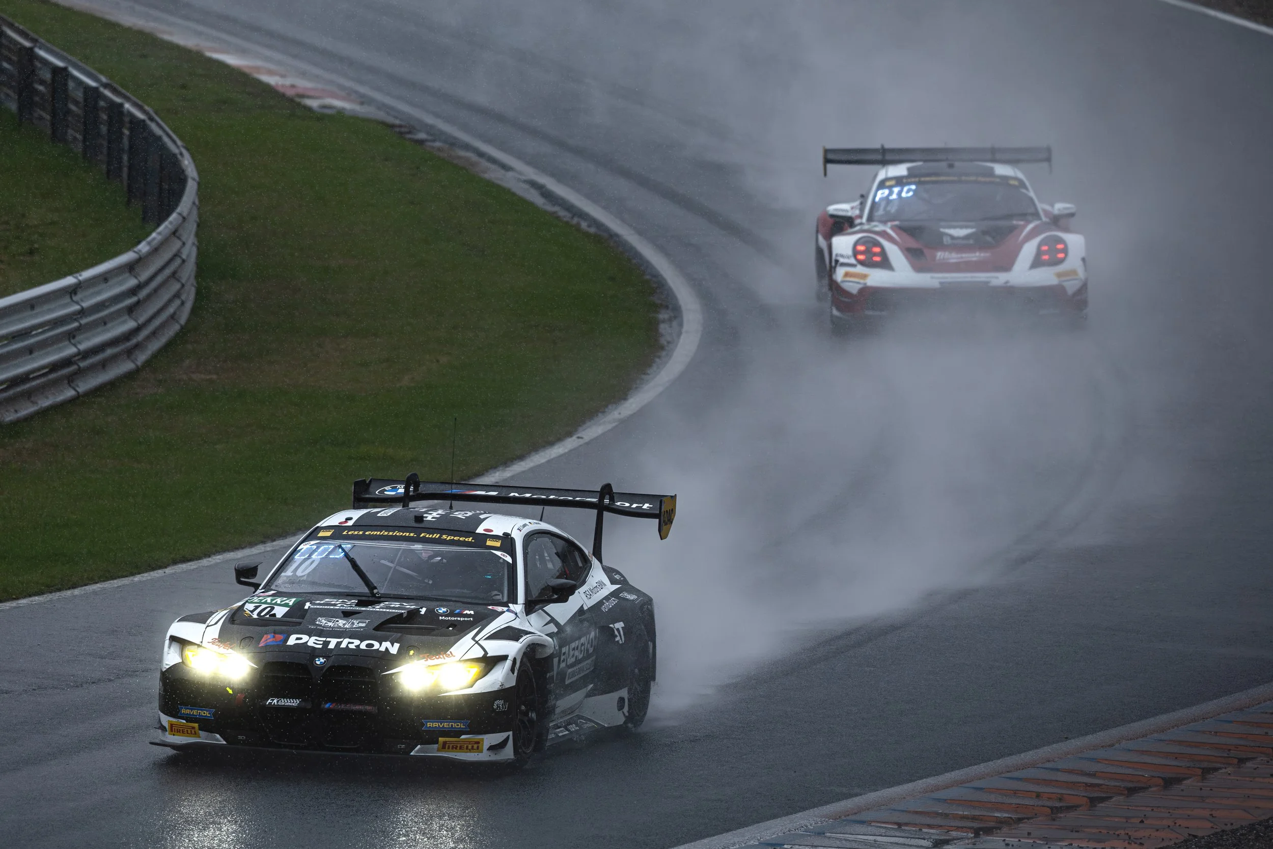 BMW M4 GT3 driving through a rain soaked Scheivlak during the Zandvoort round of the 2025 ADAC GT Masters.