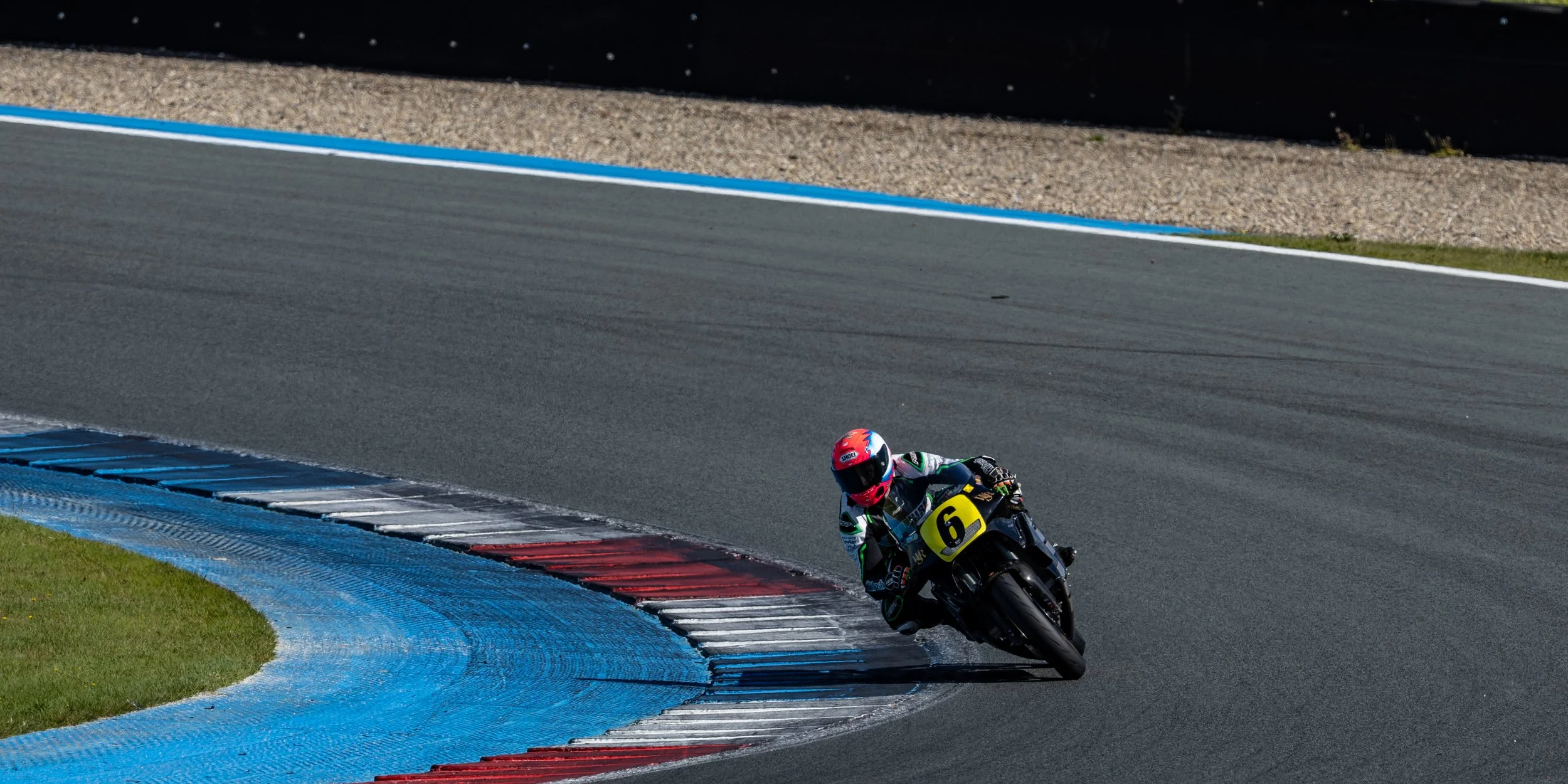 A motorcycle racing through turn 8, also known as Stekkenwal, at TT circuit Assen at the Tabac Classic GP 2025.