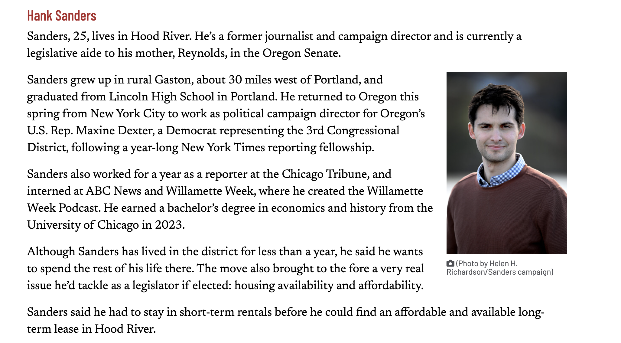 A page from a biography of Hank Sanders, a 25-year-old man living in Hood River, Oregon, with a photo of him on the right side. The photo shows a young man with short dark hair, wearing a brown sweater over a blue checkered shirt, standing outdoors with a blurred background. The caption under the photo reads: 'Photo by Helen H. Richardson/Sanders campaign.'