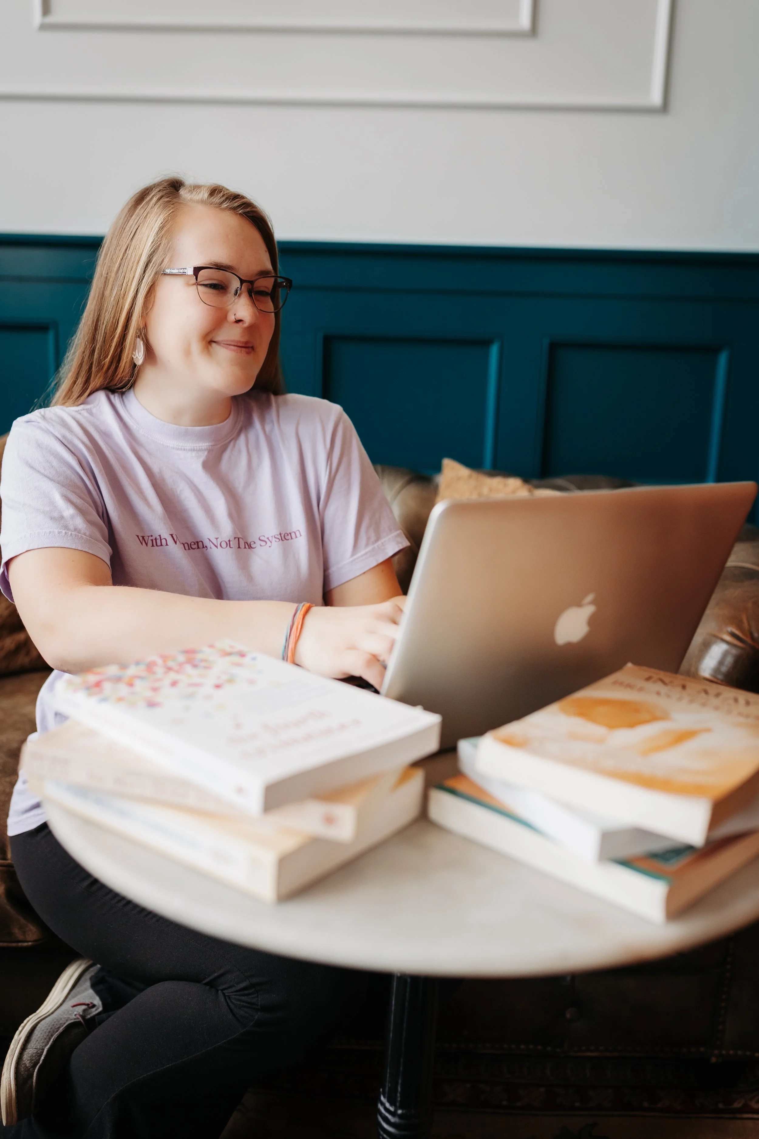Brook + Brave Birth - Memphis, Tennessee Birth and Postpartum Doula working on a MacBook with Childbirth Education Books