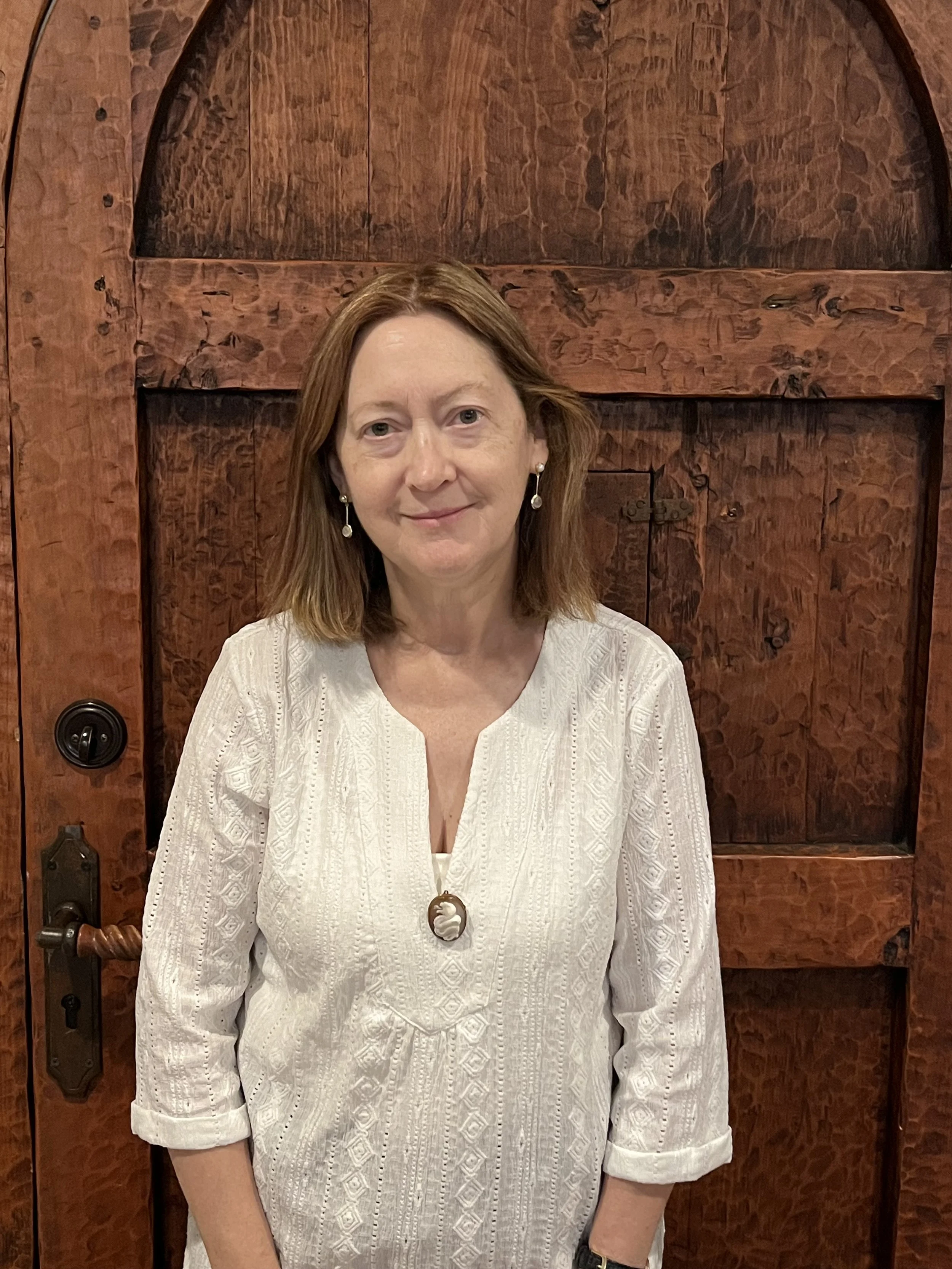 Michèle Cloonan in front of a wooden door