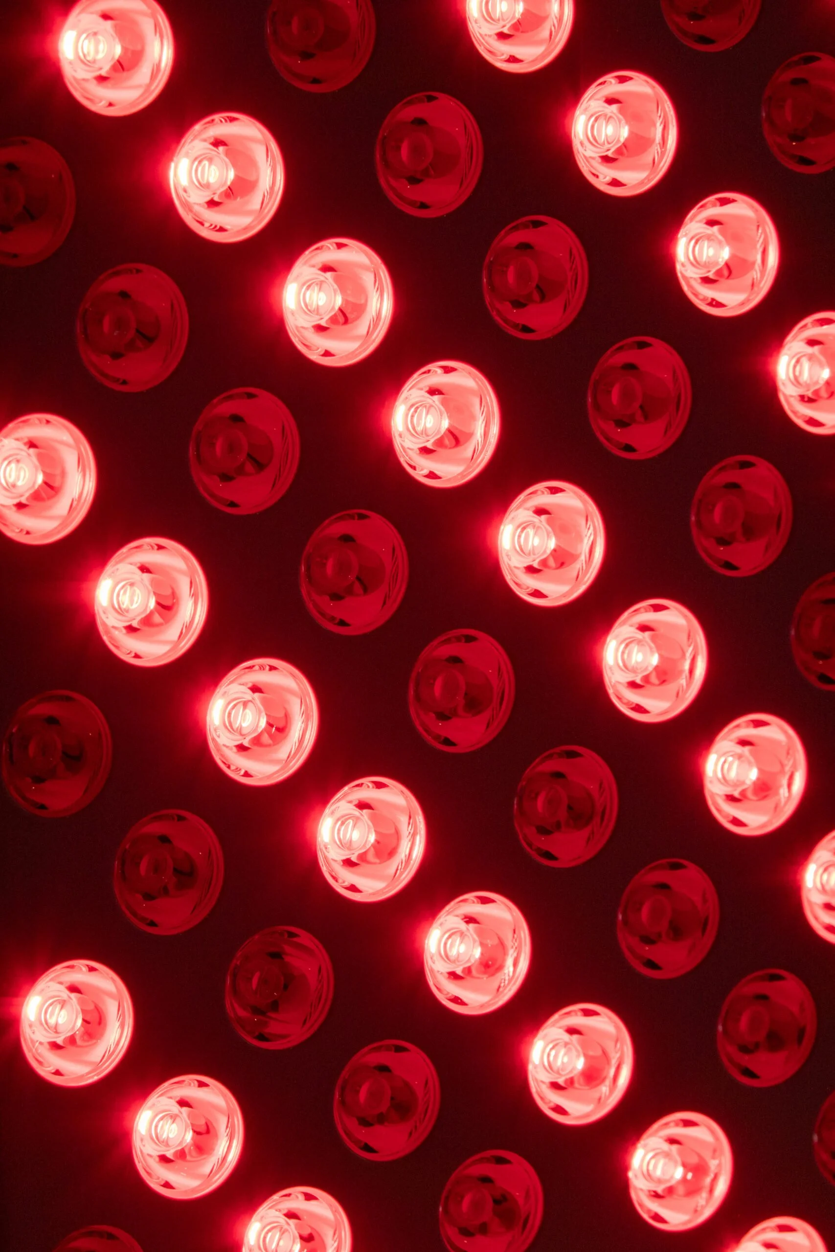 Close-up view of multiple red LED lights arranged in a pattern on a dark surface.