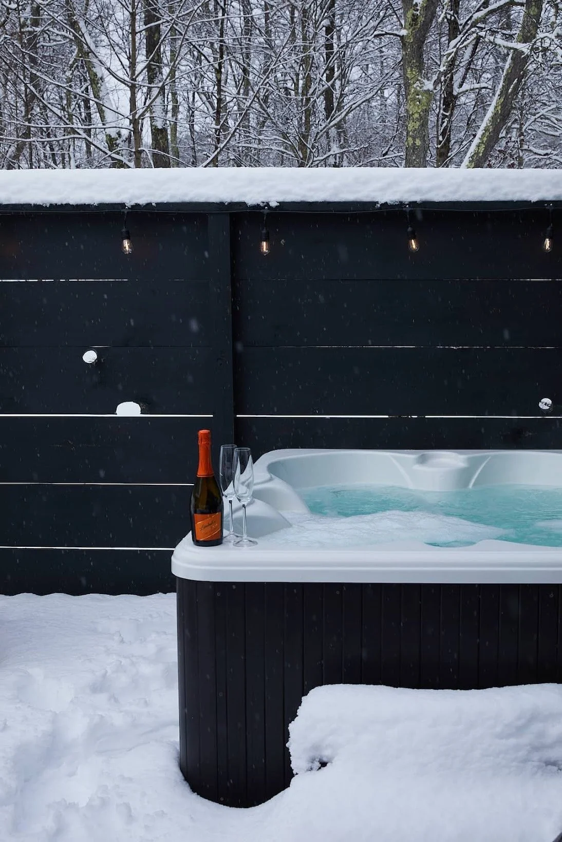 Year-round outdoor hot tub at Black Bear Cottage overlooking the forest in Livingston Manor, Catskills