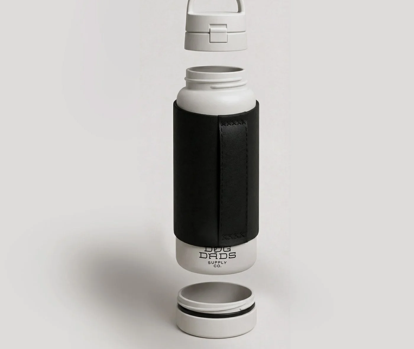 Insulated white water bottle with a black holder, open with the lid and straw separated, displaying the brand name Dog Dads Supply Co.