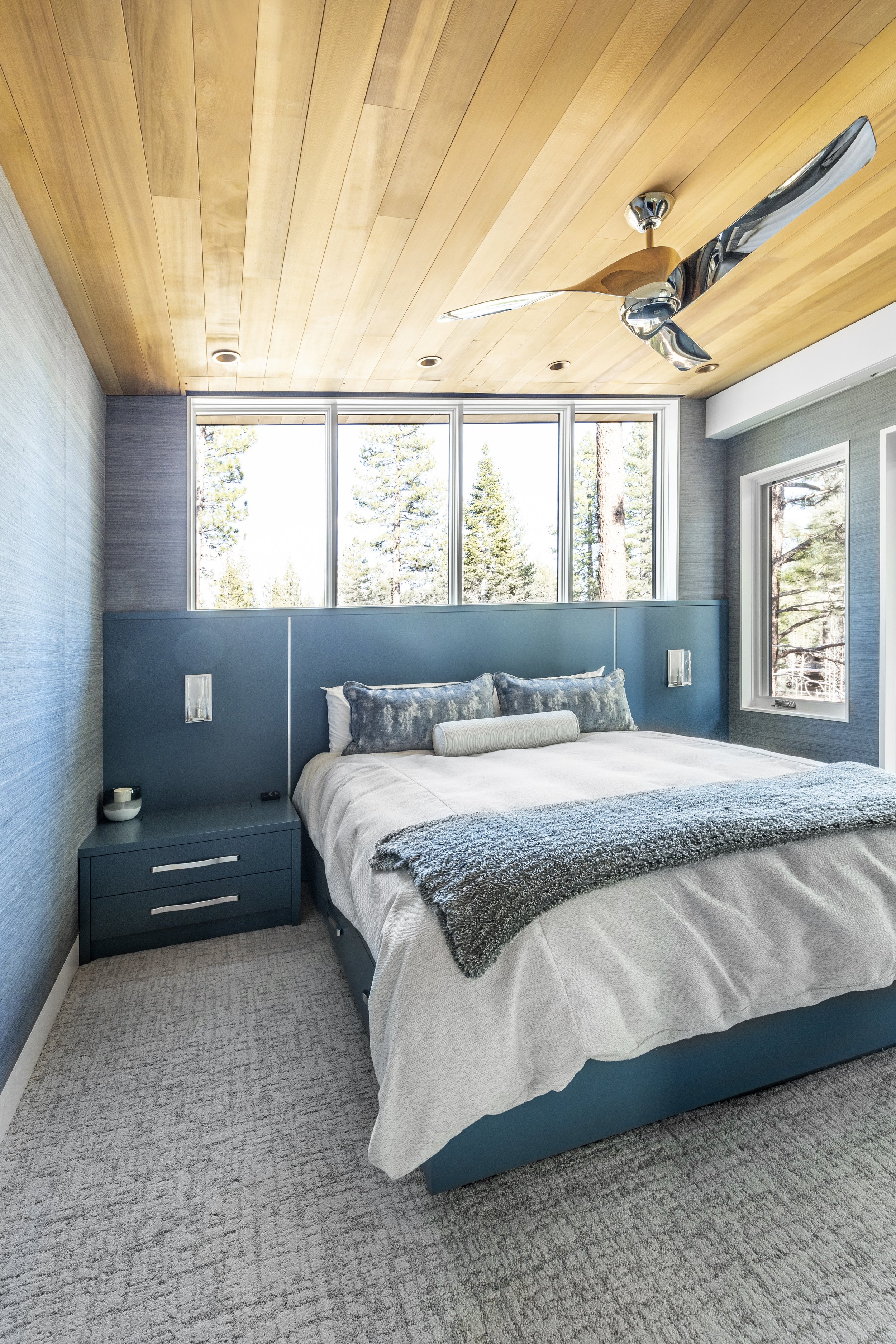 Custom designed and built-in bed, headboard, and nightstands that have hidden outlets for charging devices. Walls covered in wallpaper and the ceiling is clad in cedar T&G wood in Martis Camp in Truckee, CA.