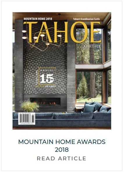 Cover of Tahoe Quarterly magazine featuring a modern living room with large windows overlooking trees, with a fireplace and a dark sofa.