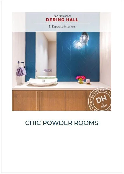 A magazine page featuring a bathroom with a white countertop, a vessel sink, a purple towel on a towel ring, a small pink flower arrangement, and a lit wall sconce, with blue tiled wall behind.